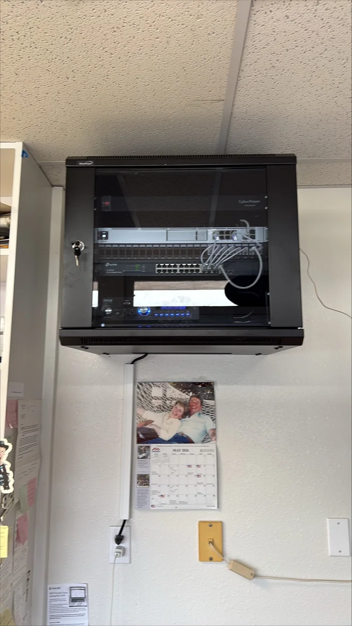 Wall-mounted network and audio-video equipment rack installed by Mitec