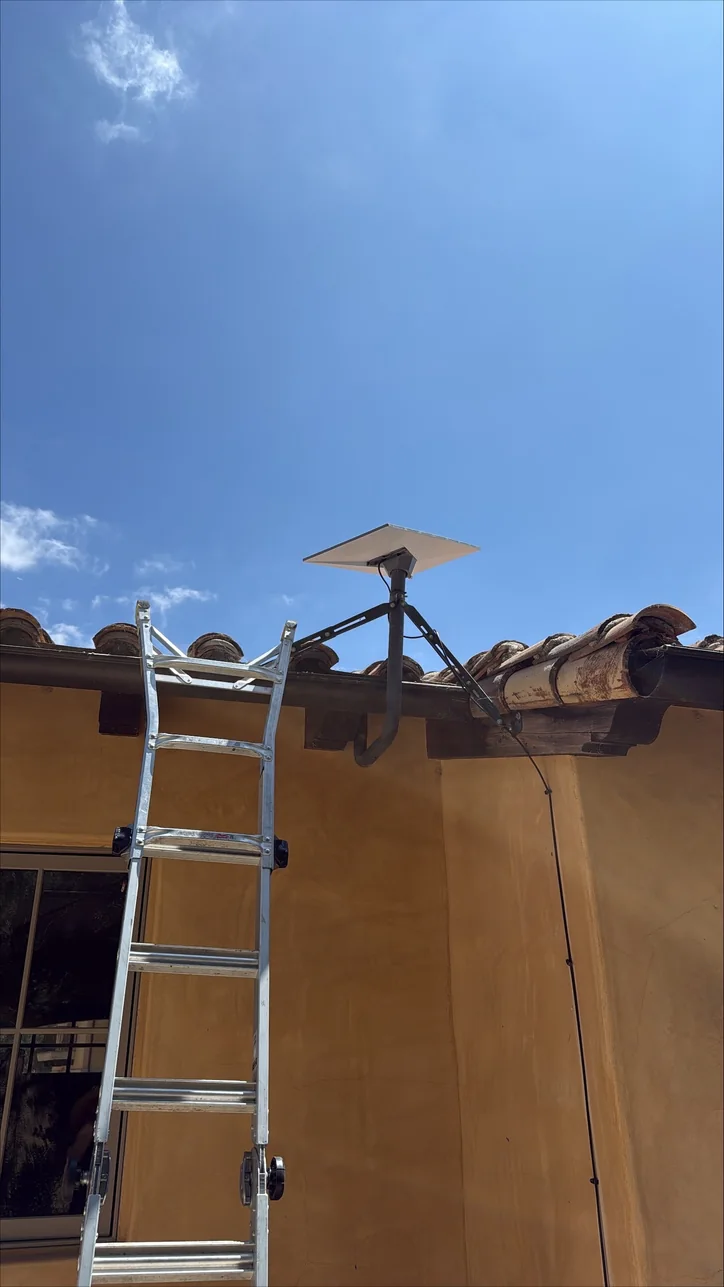Roof-mounted Starlink terminal installed by Mitec against a clear sky