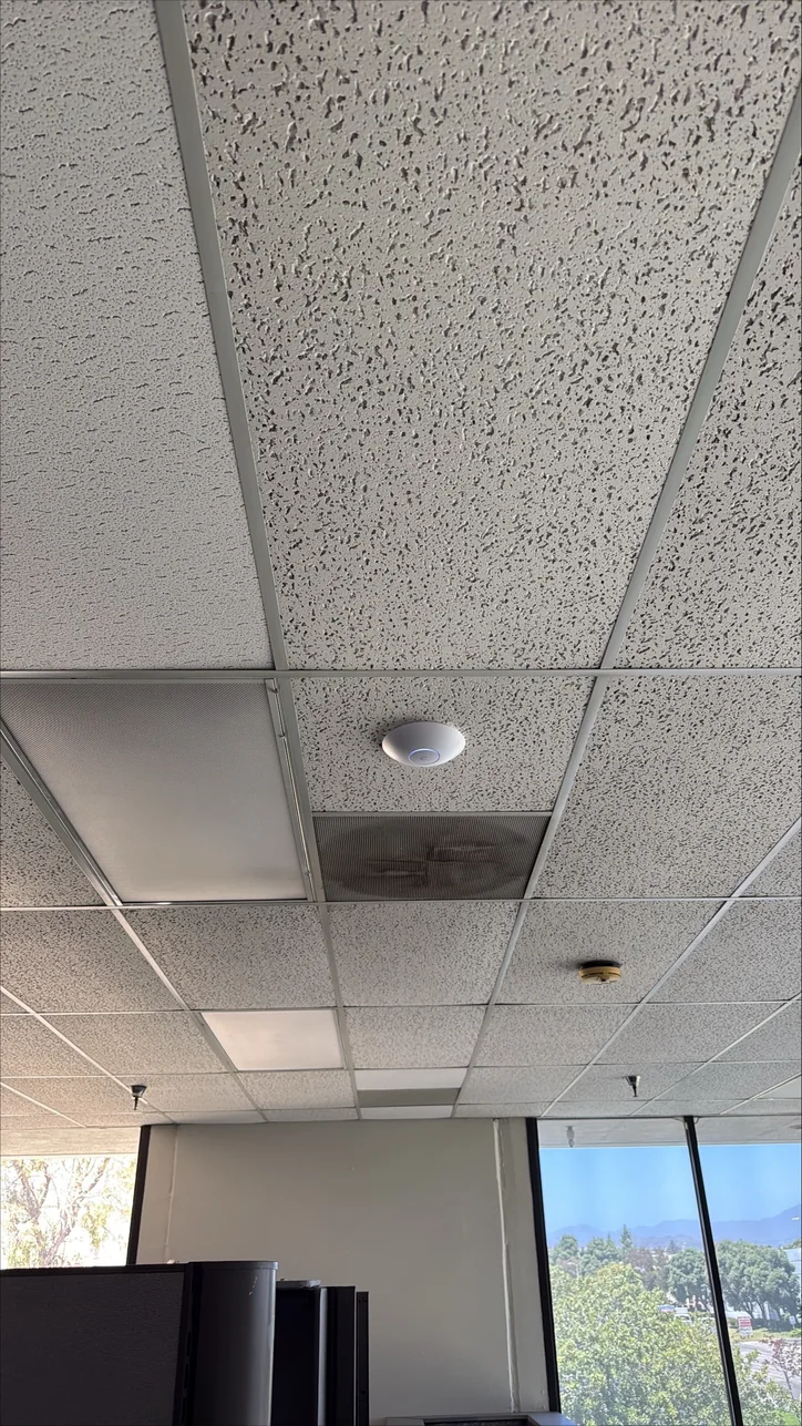 Ceiling-mounted wireless access point installed by Mitec in an office