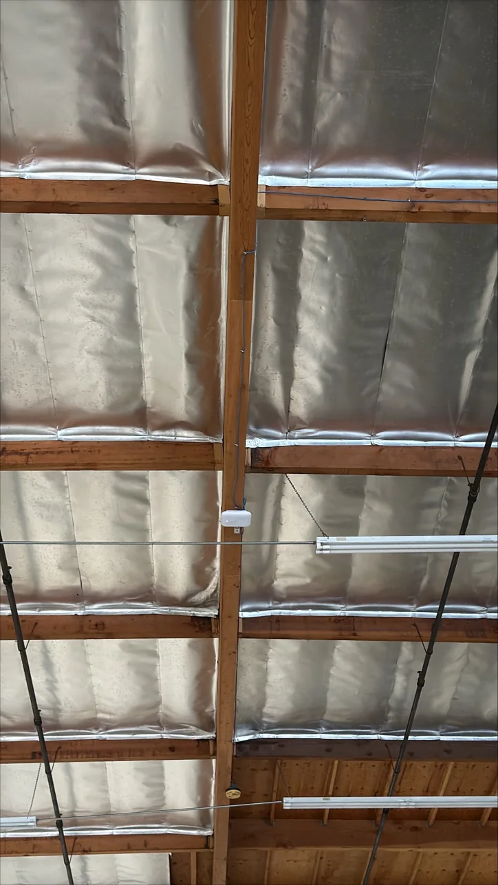 Wireless access point installed by Mitec on the open ceiling of a warehouse